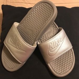 Silver Nike slides